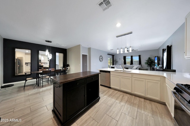 12731 W Myrtle Ave, Glendale, AZ 85307 - kitchen with stainless steel appliances, a chandelier, open floor plan, wood counters, and a peninsula