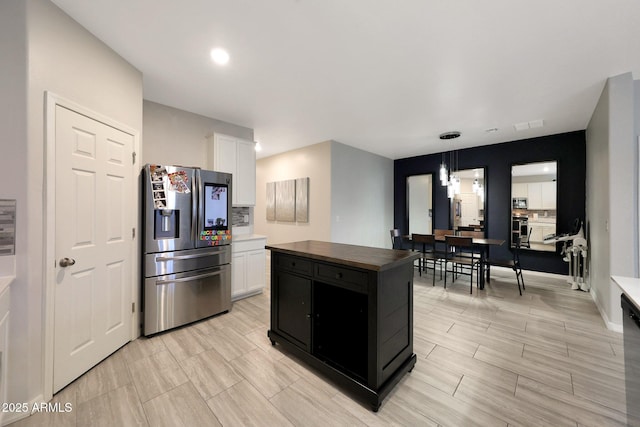 12731 W Myrtle Ave, Glendale, AZ 85307 - kitchen with stainless steel fridge with ice dispenser, white cabinetry, wood counters, a center island, and pendant lighting