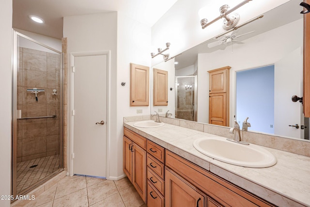full bath featuring a ceiling fan, a shower stall, double vanity, and tile patterned flooring