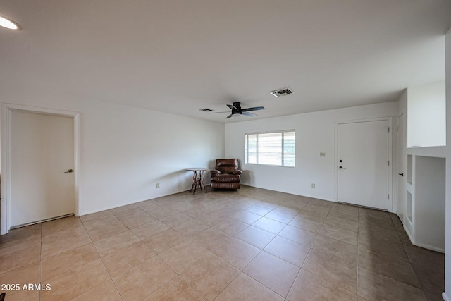 unfurnished room featuring light tile patterned floors and ceiling fan