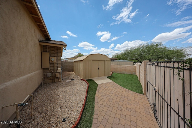 fenced backyard with a shed, a patio, and an outdoor structure
