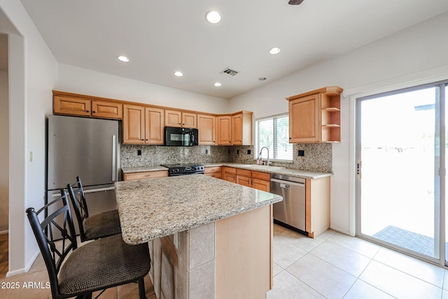 kitchen with black appliances, a center island, backsplash, a sink, and open shelves