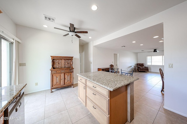 kitchen featuring a ceiling fan, open floor plan, recessed lighting, light tile patterned floors, and a kitchen island