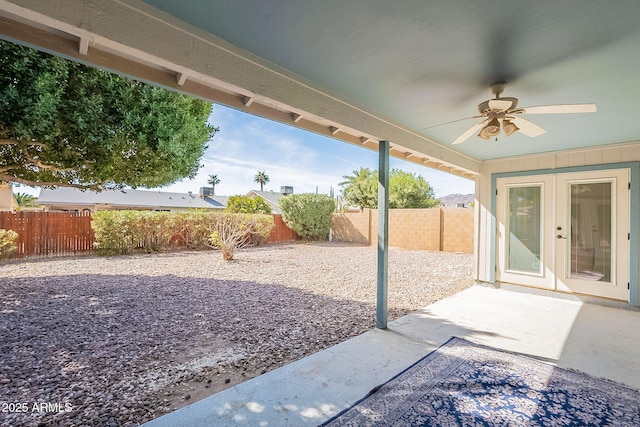 view of patio featuring french doors, a fenced backyard, and ceiling fan