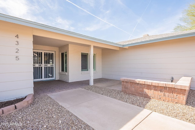 entrance to property featuring a patio area