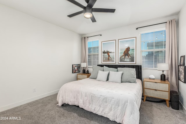 carpeted bedroom with baseboards and ceiling fan