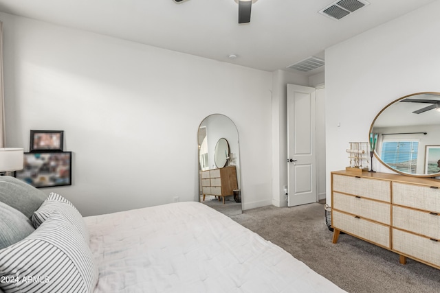 carpeted bedroom featuring visible vents, arched walkways, baseboards, and ceiling fan