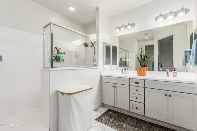 bathroom with a sink, marble finish floor, a walk in shower, and double vanity