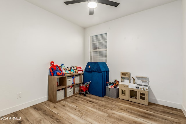 game room with ceiling fan, baseboards, and wood finished floors