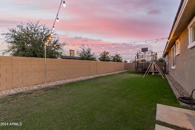 view of yard featuring a fenced backyard and a trampoline