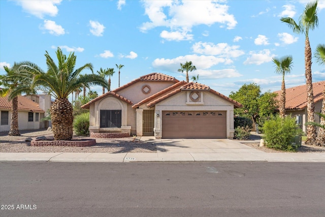 6719 W Sack Dr, Glendale, AZ 85308 - mediterranean / spanish home featuring an attached garage, concrete driveway, stucco siding, and a tiled roof