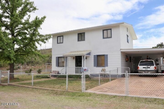 view of front of home with a front yard and a carport