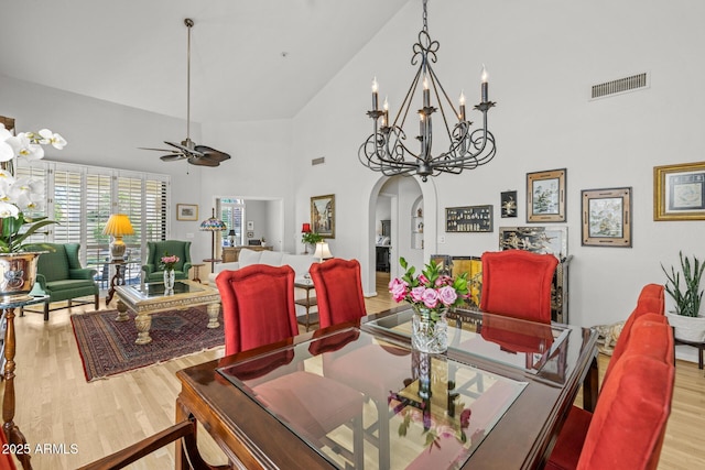 10429 N 101st St, Scottsdale, AZ 85258 - dining area featuring arched walkways, wood finished floors, a towering ceiling, ceiling fan, and a chandelier