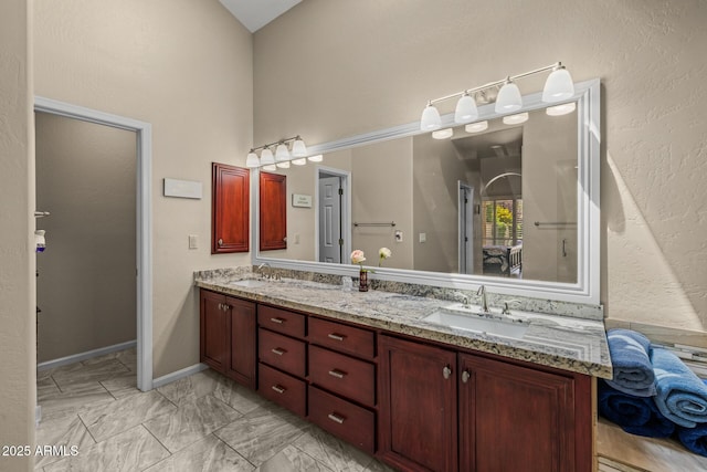 10429 N 101st St, Scottsdale, AZ 85258 - full bathroom featuring double vanity, high vaulted ceiling, and marble finish floors