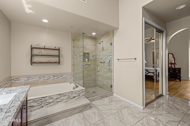 10429 N 101st St, Scottsdale, AZ 85258 - ensuite bathroom with a shower stall, a garden tub, baseboards, vanity, and marble finish floors