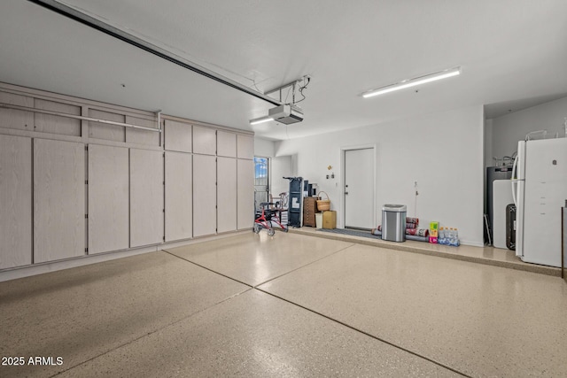 10429 N 101st St, Scottsdale, AZ 85258 - garage with a garage door opener, freestanding refrigerator, and fridge