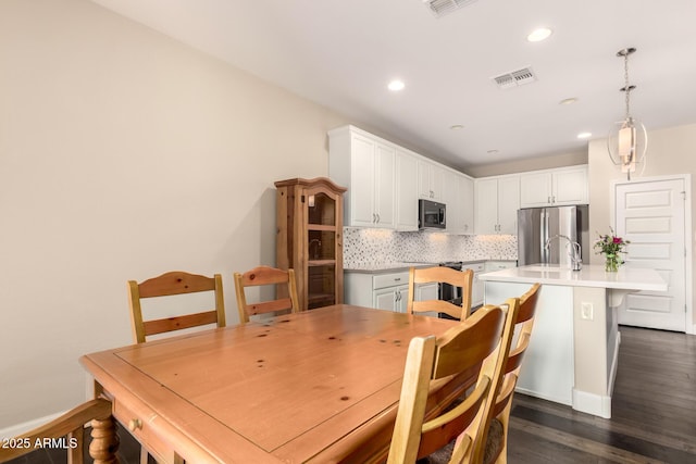 5754 N Aztec Dr, Eloy, AZ 85131 - dining space featuring dark wood-style flooring, recessed lighting, and baseboards