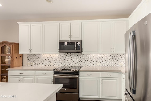 5754 N Aztec Dr, Eloy, AZ 85131 - kitchen featuring stainless steel appliances, light countertops, white cabinetry, and decorative backsplash