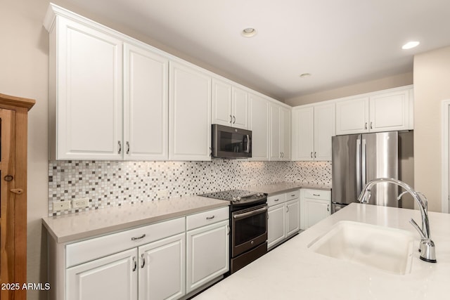 5754 N Aztec Dr, Eloy, AZ 85131 - kitchen featuring stainless steel appliances, a sink, white cabinetry, light countertops, and recessed lighting