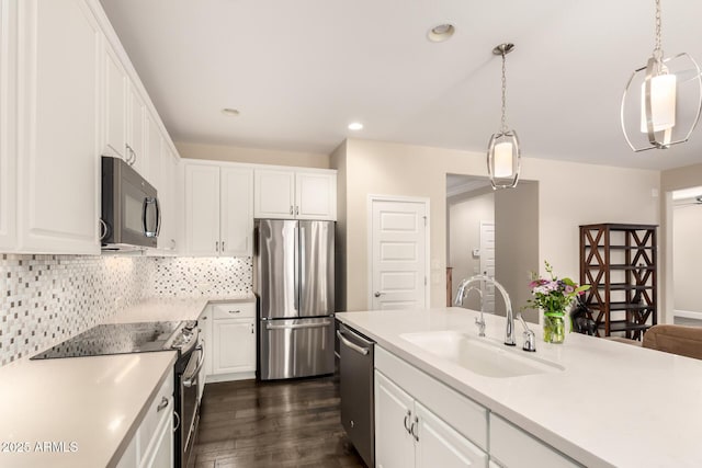 5754 N Aztec Dr, Eloy, AZ 85131 - kitchen with stainless steel appliances, a sink, white cabinetry, dark wood-style floors, and recessed lighting