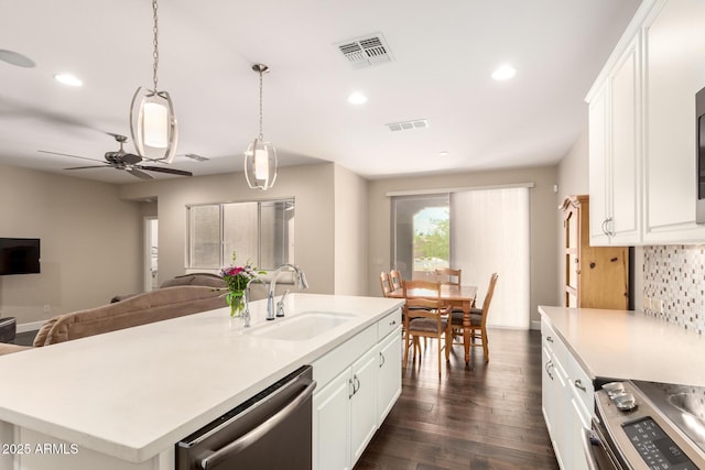 5754 N Aztec Dr, Eloy, AZ 85131 - kitchen featuring appliances with stainless steel finishes, a sink, open floor plan, decorative backsplash, and a ceiling fan