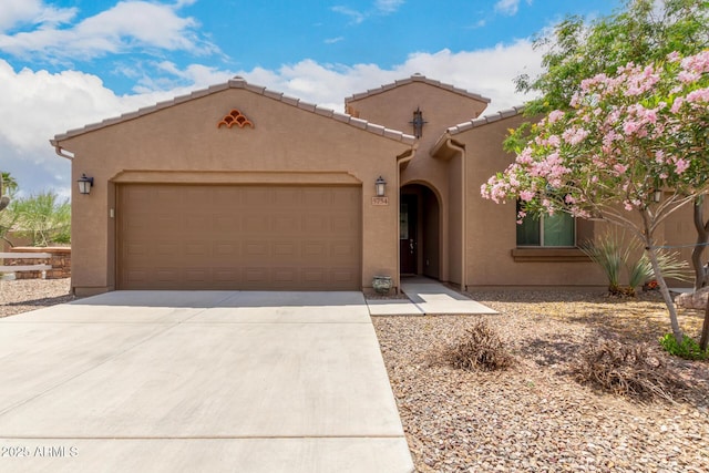 5754 N Aztec Dr, Eloy, AZ 85131 - mediterranean / spanish-style home featuring stucco siding, a garage, concrete driveway, and a tiled roof
