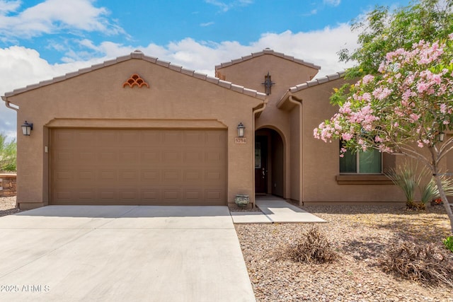 5754 N Aztec Dr, Eloy, AZ 85131 - mediterranean / spanish-style home with stucco siding, an attached garage, and driveway