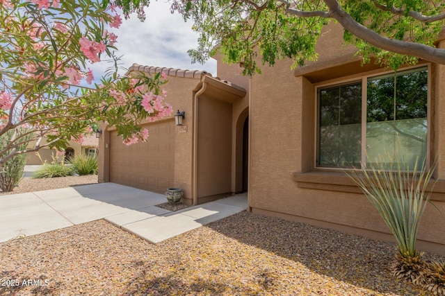 5754 N Aztec Dr, Eloy, AZ 85131 - view of front of home featuring stucco siding, driveway, and an attached garage