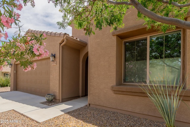 5754 N Aztec Dr, Eloy, AZ 85131 - property entrance with stucco siding, a garage, and concrete driveway
