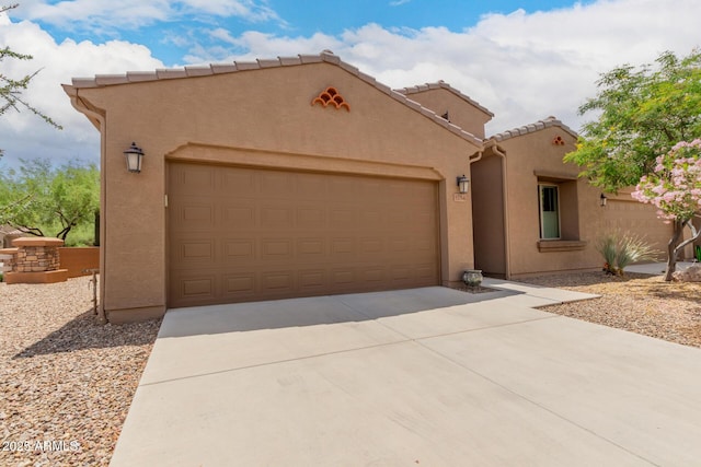 5754 N Aztec Dr, Eloy, AZ 85131 - view of front of property featuring an attached garage, concrete driveway, stucco siding, and a tile roof