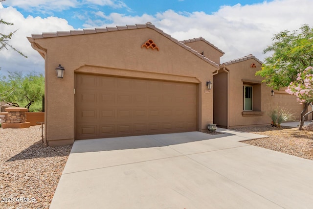 5754 N Aztec Dr, Eloy, AZ 85131 - view of front of house featuring an attached garage, stucco siding, concrete driveway, and a tiled roof