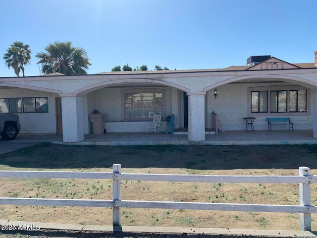 view of front of property with stucco siding and covered porch