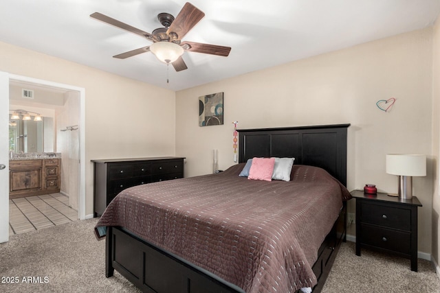 bedroom with visible vents, ensuite bathroom, a ceiling fan, carpet, and baseboards