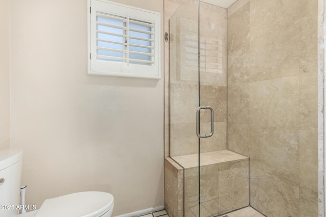 full bath featuring a shower stall, toilet, and baseboards