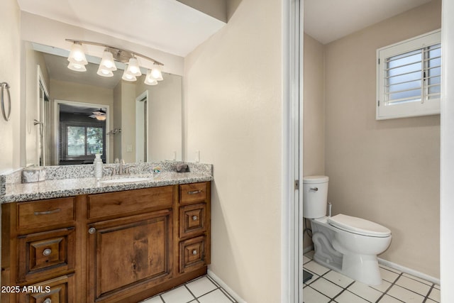 bathroom featuring baseboards, toilet, and vanity