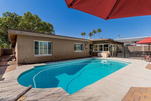 view of swimming pool featuring a patio area, a fenced in pool, and a fenced backyard