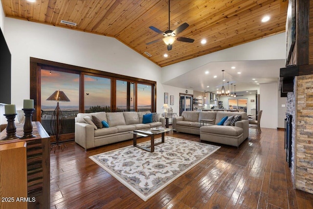 living room featuring dark hardwood / wood-style flooring, wood ceiling, a stone fireplace, and high vaulted ceiling