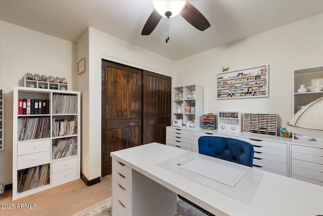 office area featuring light colored carpet and ceiling fan