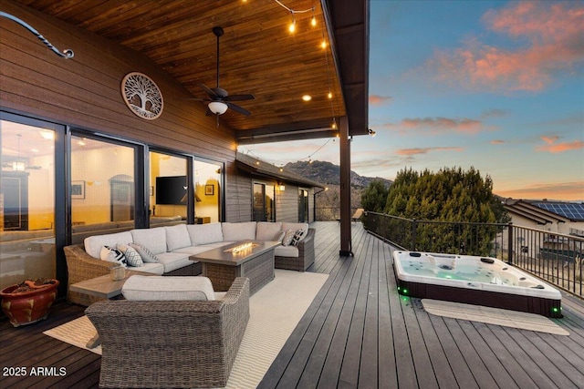 deck featuring an outdoor living space with a fire pit and ceiling fan