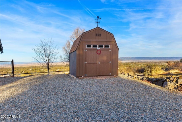 view of outdoor structure with a rural view and a mountain view