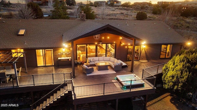 rear view of property with a wooden deck and outdoor lounge area