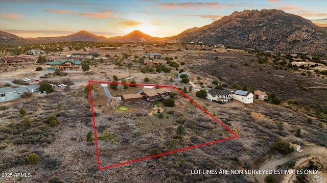 aerial view at dusk featuring a mountain view