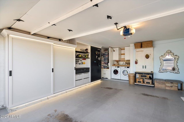 garage with separate washer and dryer and a garage door opener