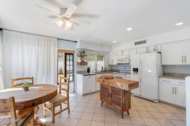 kitchen with ceiling fan, sink, light tile patterned flooring, white appliances, and white cabinets