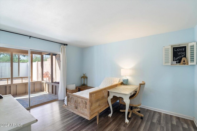 bedroom with dark hardwood / wood-style floors