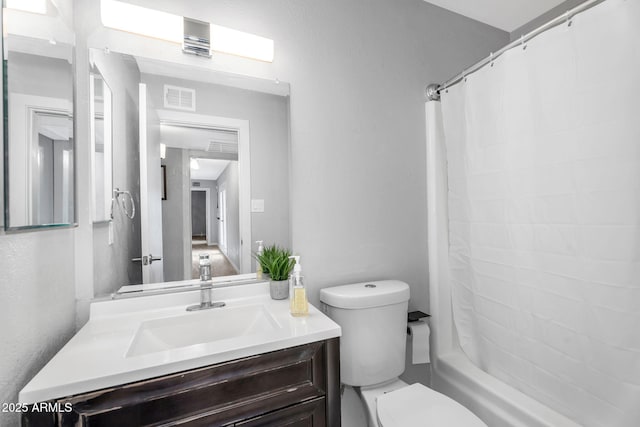 bathroom featuring shower / bath combination with curtain, toilet, vanity, and visible vents