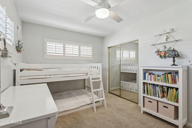 carpeted bedroom with a closet and a ceiling fan