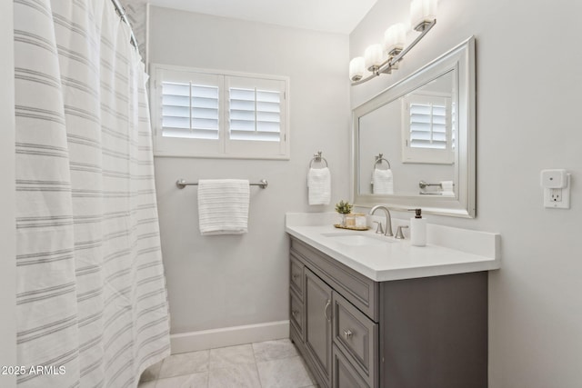 full bathroom with vanity and baseboards