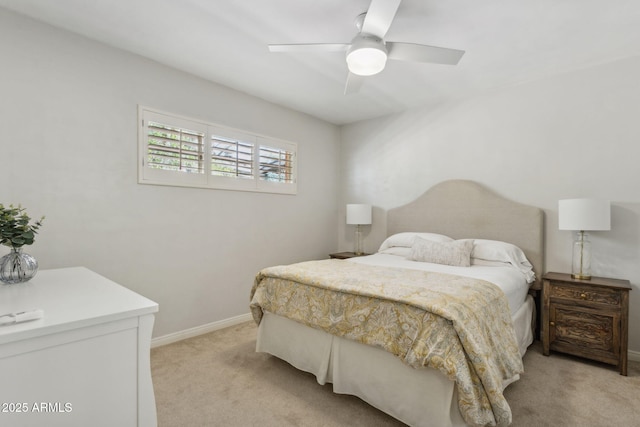 bedroom with light colored carpet, baseboards, and ceiling fan