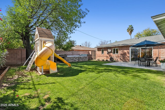 view of yard with a patio, a fenced backyard, and a playground